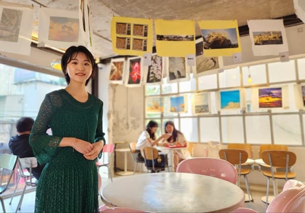 천장에 걸린 자신의 작품 앞에서 포즈를 취한 김규진 사진작가(사진=허영훈 기자)